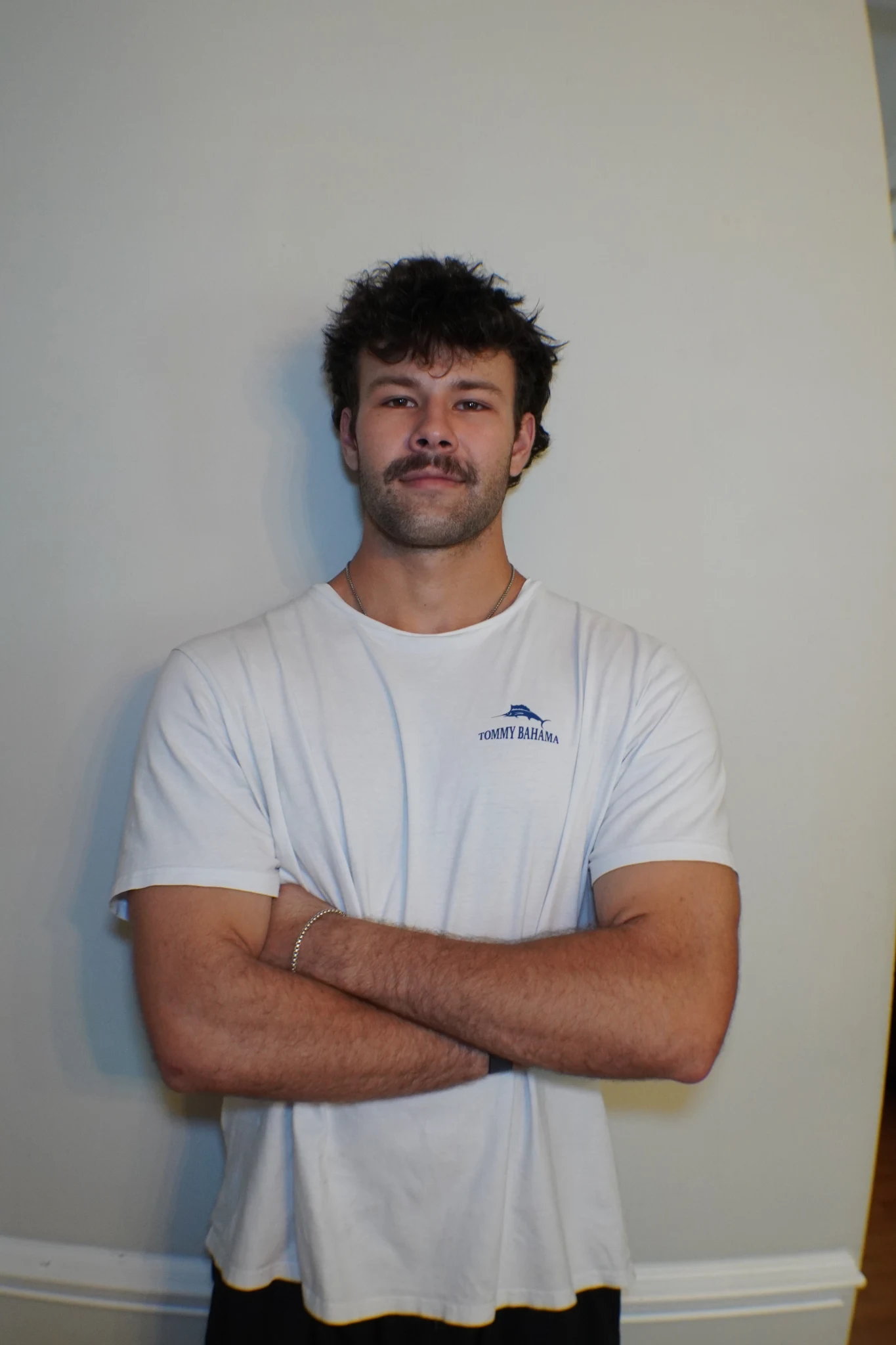 Zak Engelbrecht, founder of Peptide Insiders, standing with his arms folded